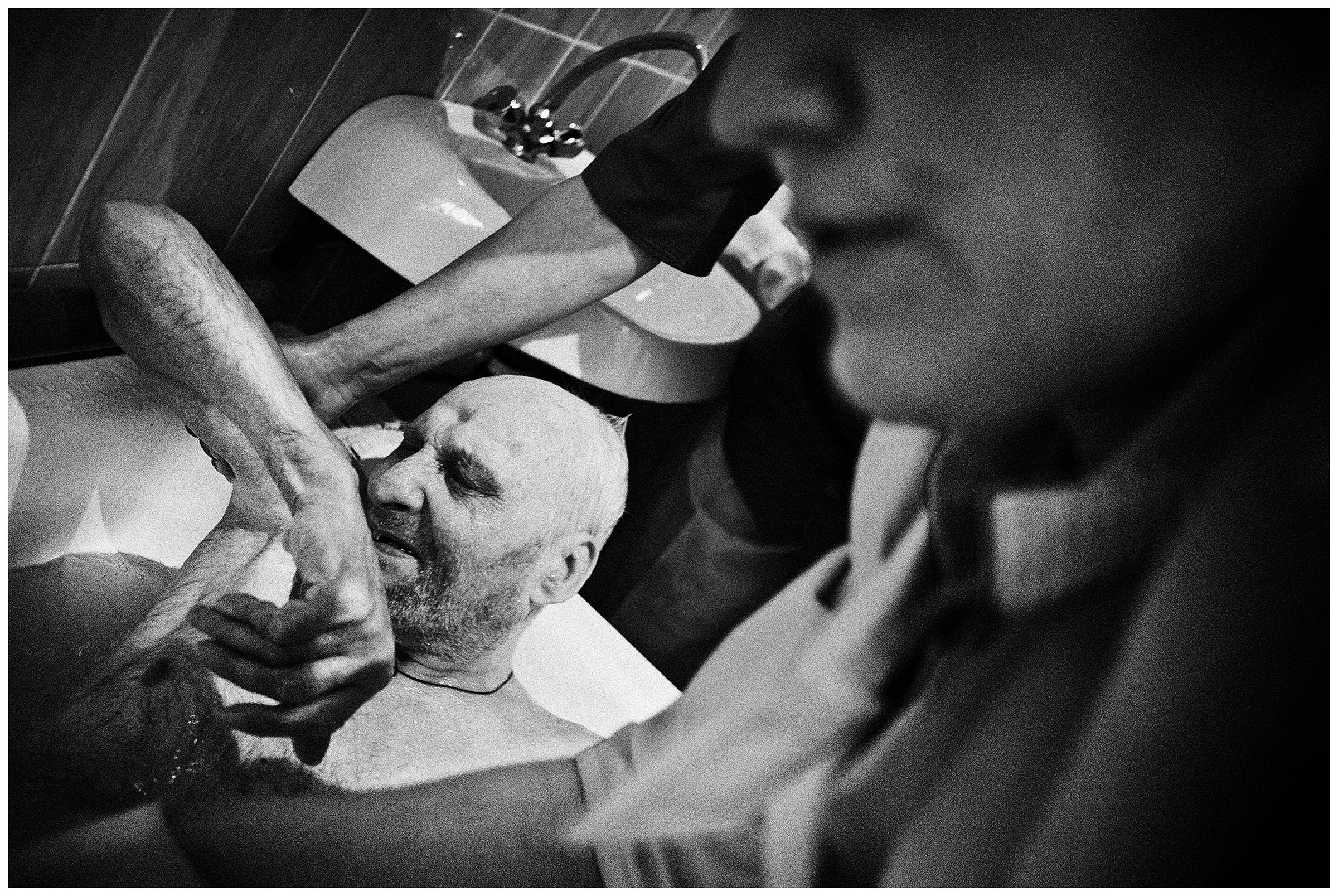 Minsk Hospice, Minsk, Belarus. A patient is bathed.