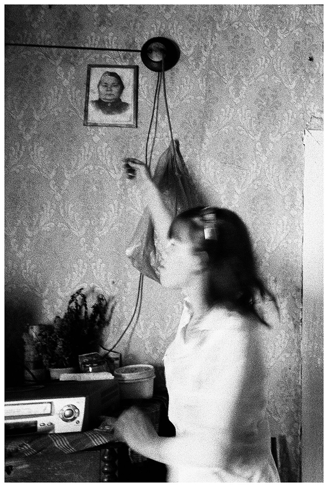 Shoyna village, Russia. A girl walks through her house.