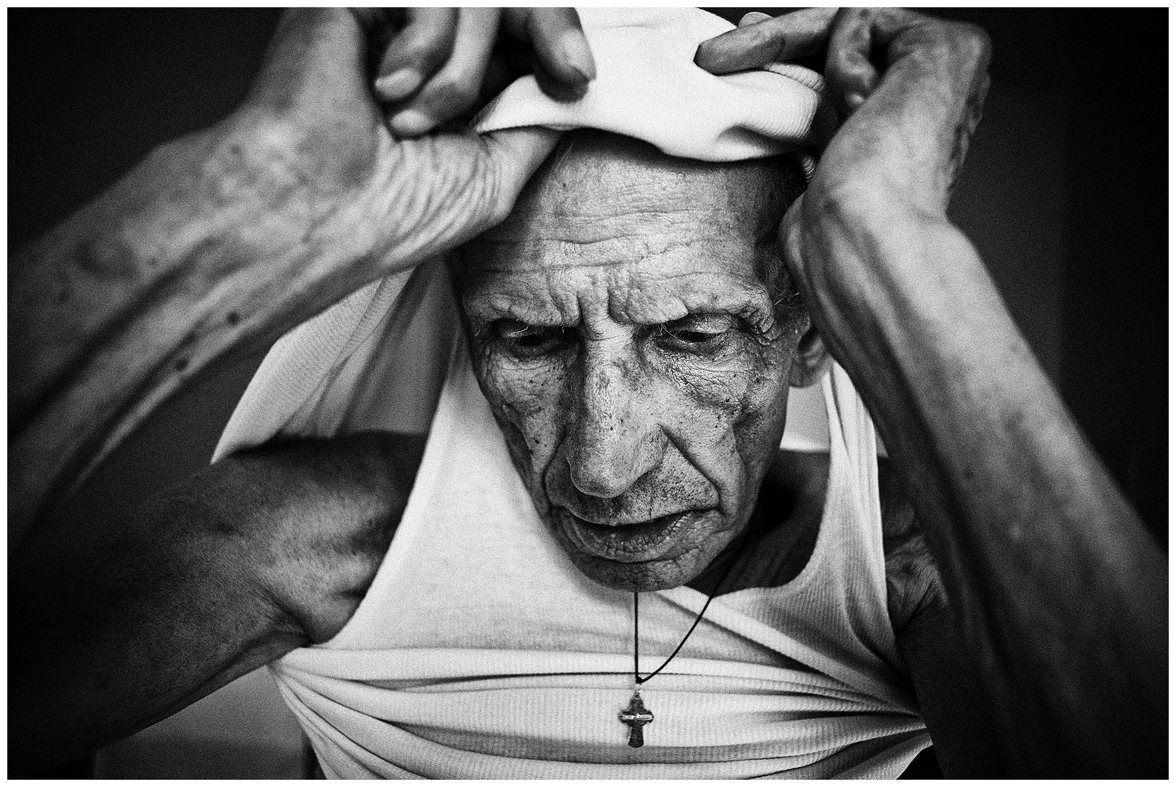 Minsk Hospice, Minsk, Belarus. A patient changes clothes.