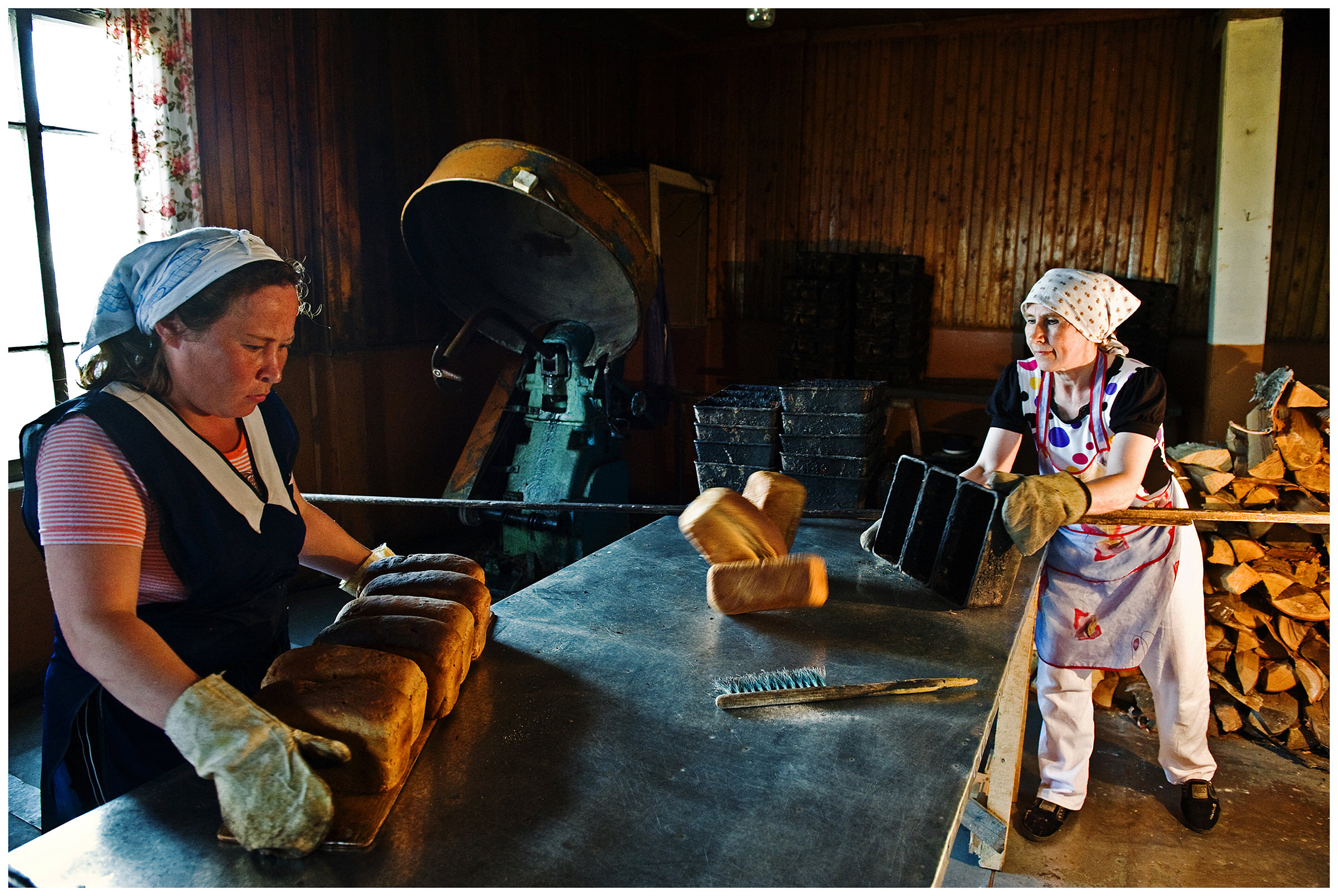 Shoyna village, Russia. Two women work in the village bakery. They bake bread.