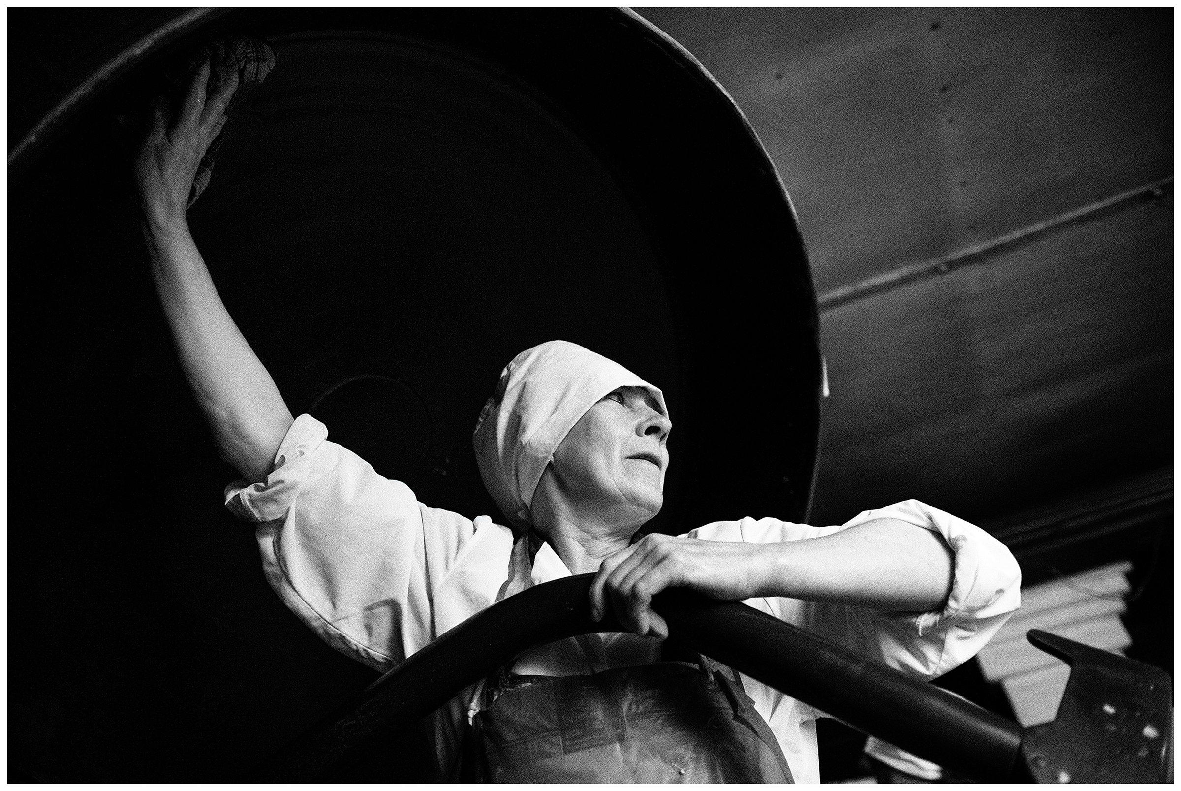 Shoyna village, Russia. A baker washes a machine for the dough.