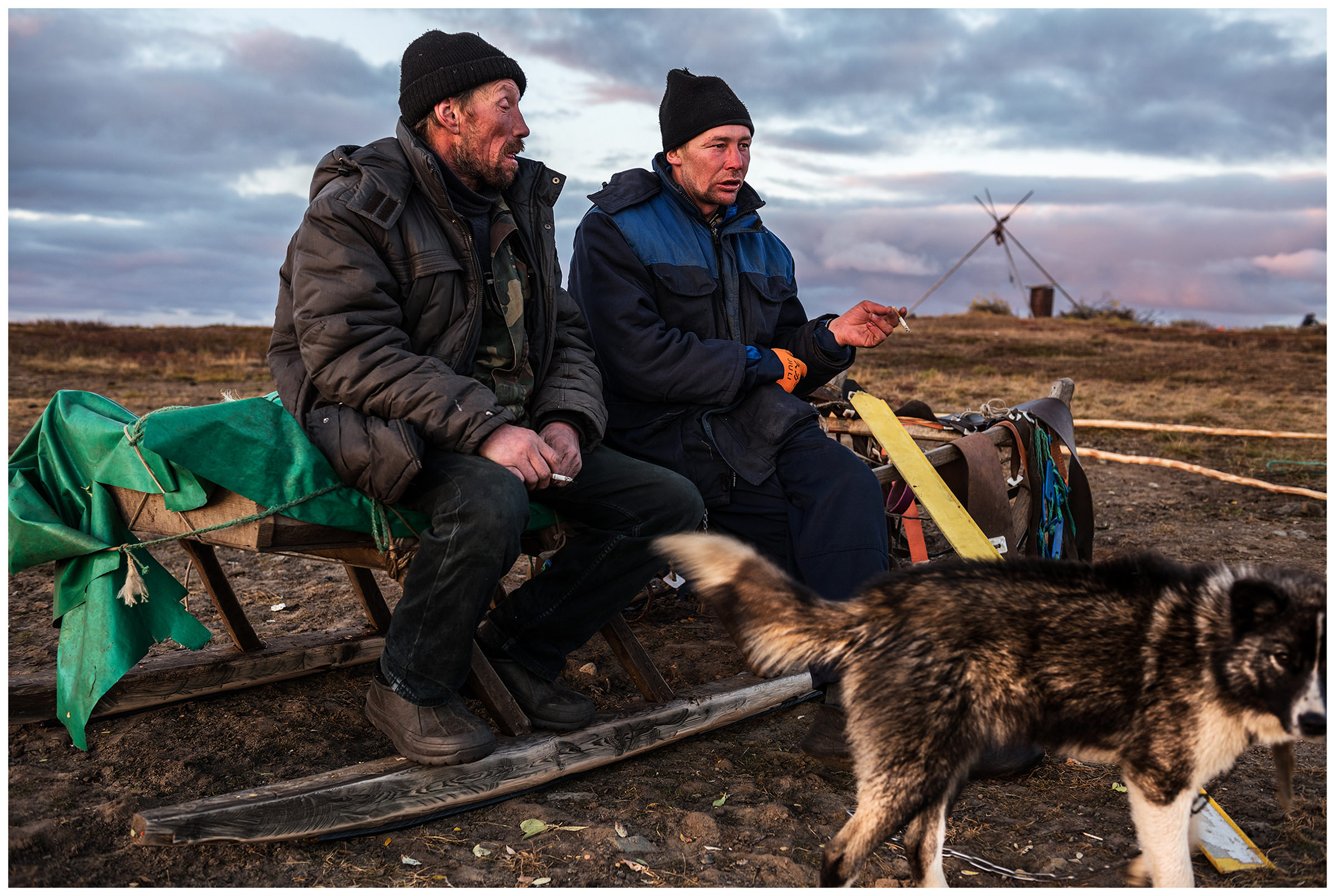 Nenets Autonomous Okrug, Komi Republic, Russia. Reindeer herders smoke on their sleds.
