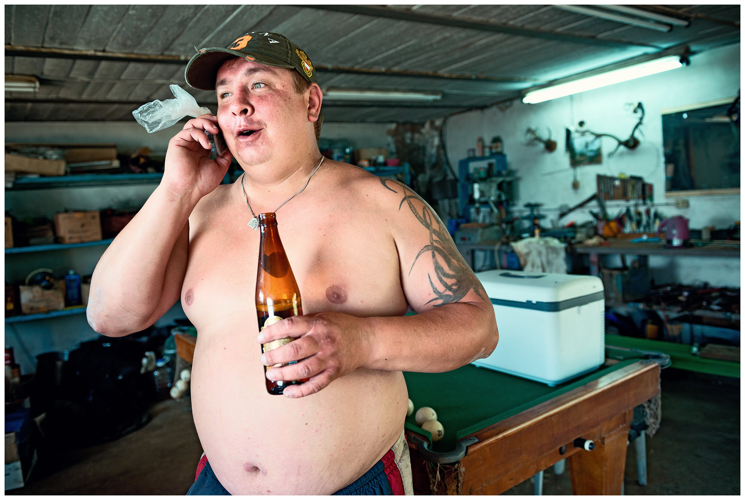 Primorye, Russia A poacher takes his engine to a workshop and waits until it is repaired.