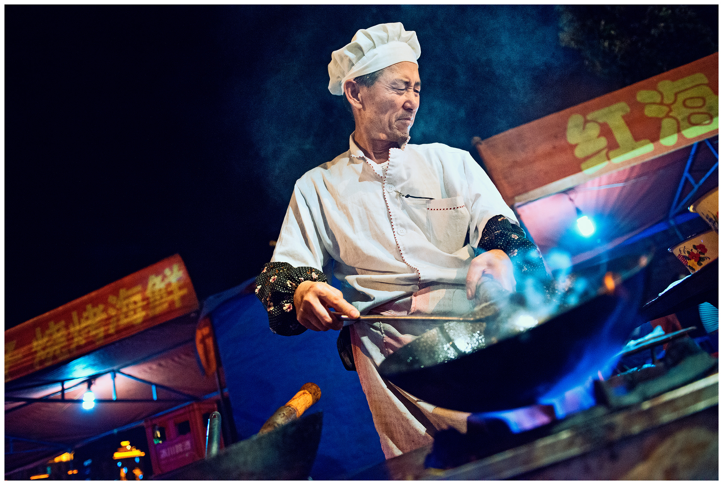 Hunchun, China. A man prepares seafood at the fish market. Most of the delicacies sold and prepared at the Hunchun fish market in China come from Russia.