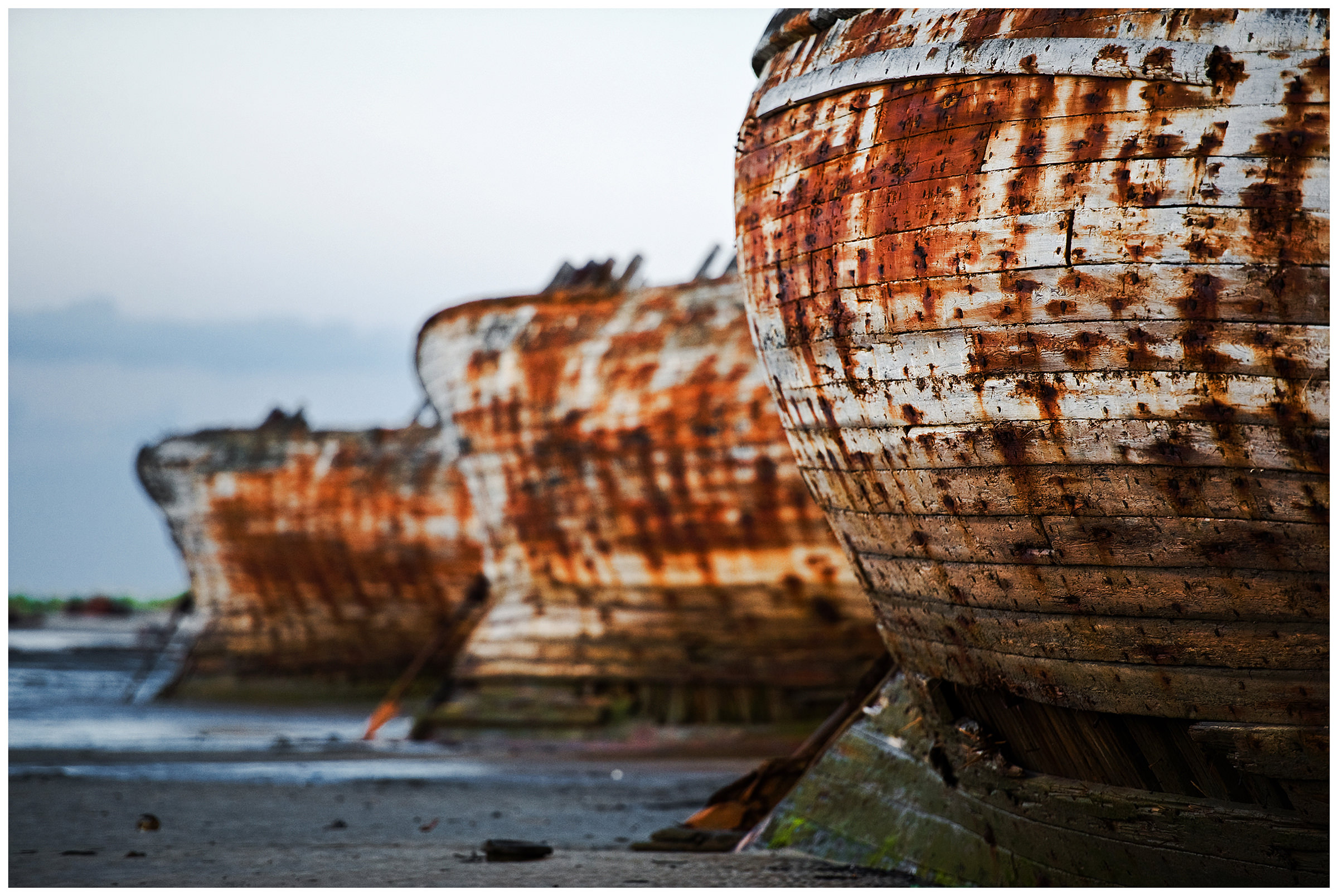 Shoyna village, Russia. Ship wraks stand on the coast.