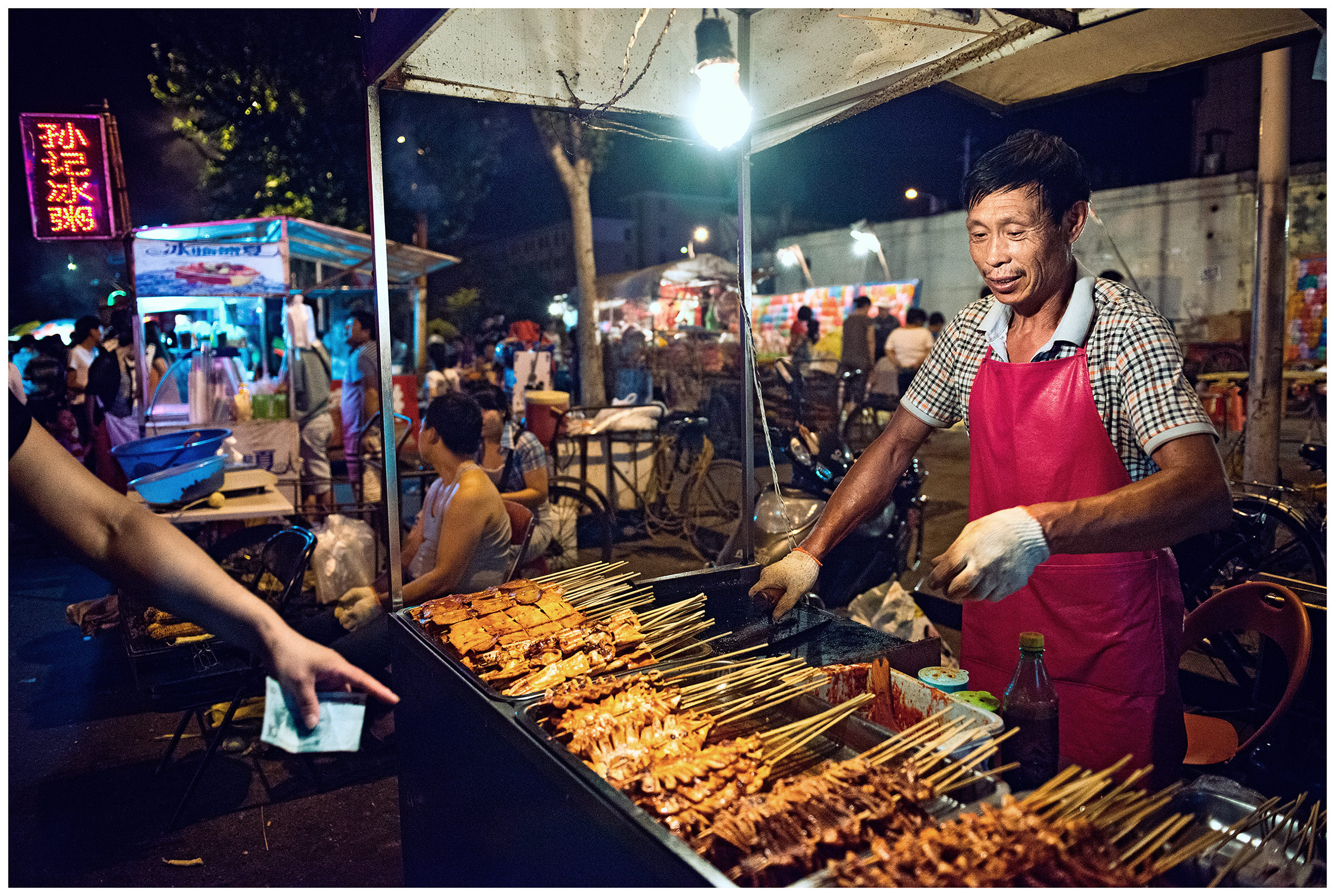 Hunchun, China. A man prepares and sells seafood at the fish market. Most of the delicacies sold and prepared at the Hunchun fish market in China come from Russia.