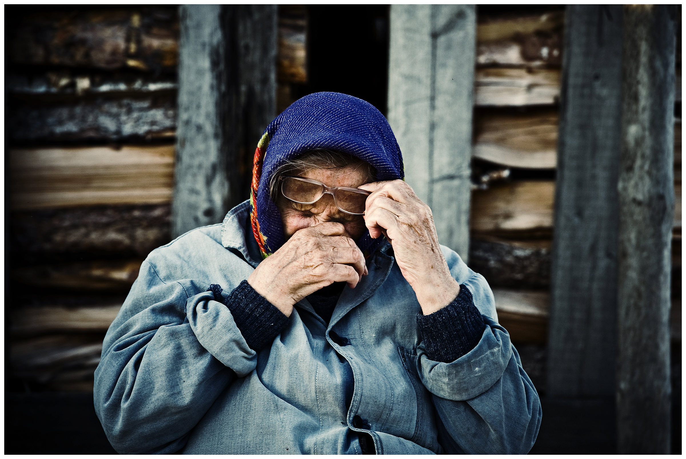 Shoyna village, Russia. An old woman rubs her eyes after a violent sandstorm.