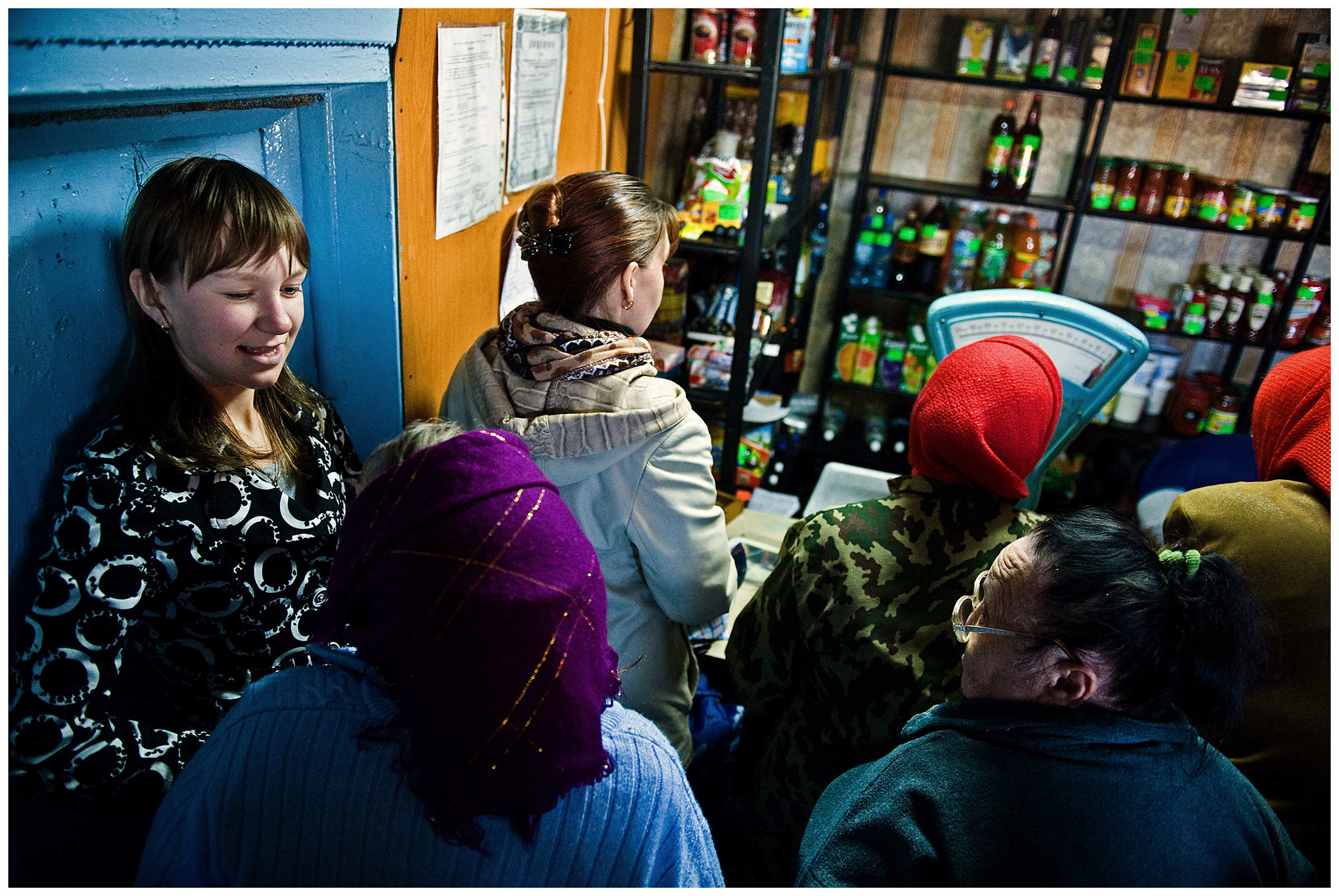 Shoyna village, Russia. People talk to each other in a village shop.
