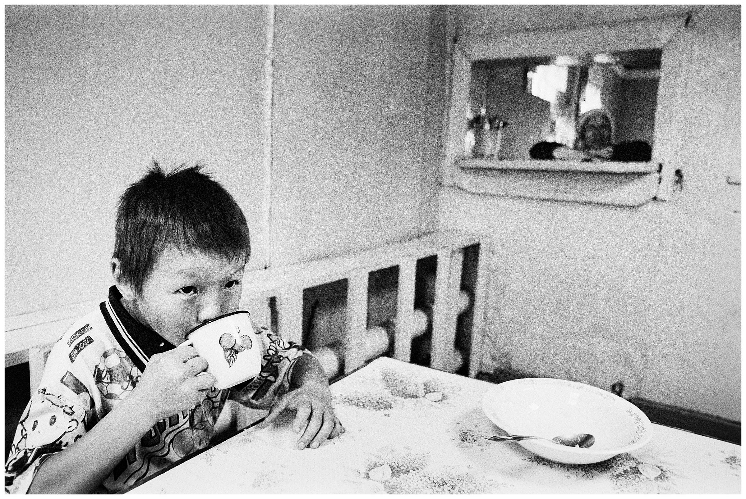 A boy in boarding school drinks tea