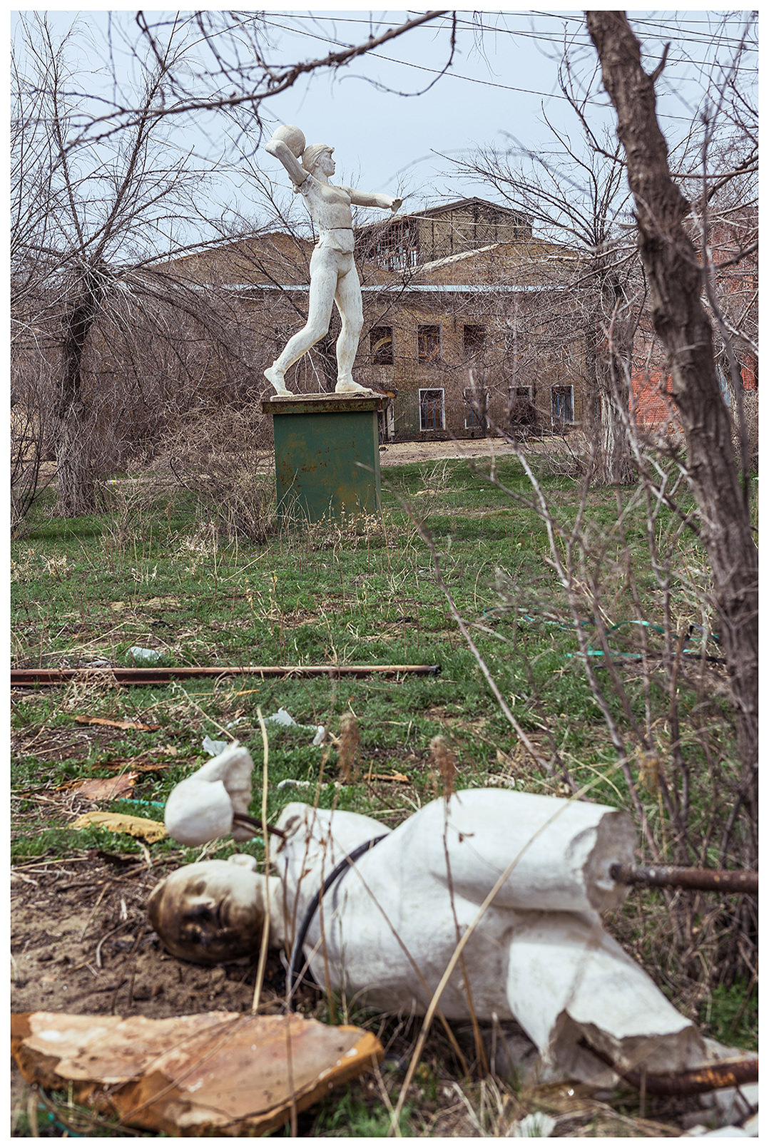 A statue from the Soviet era lies on the ground on the site of the former ship repair yard.