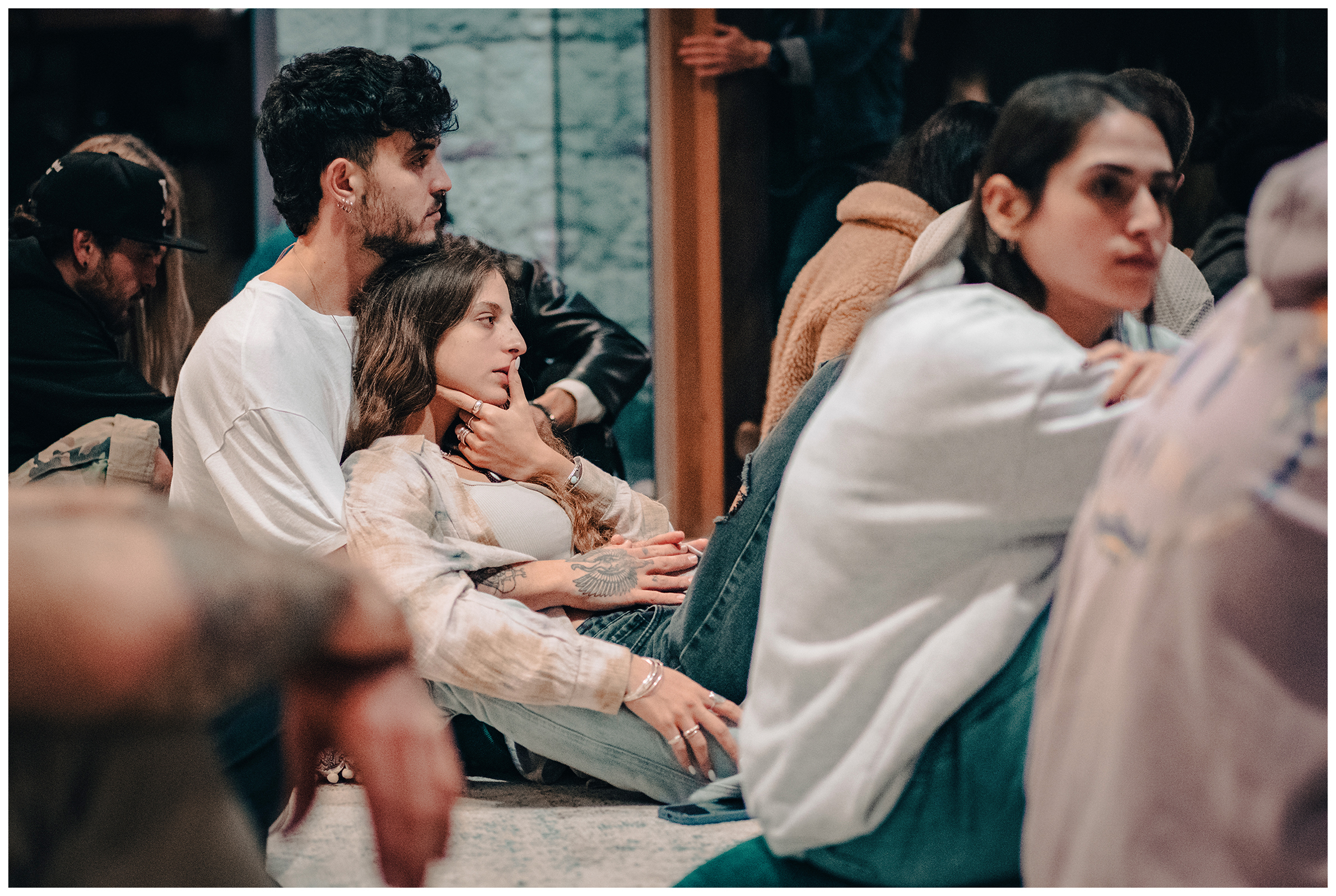 Miliou, Cyprus. The new arrivals from Israel sit in a meditation room in the Secret Forest wellness retreat. A young man hugs a young woman.