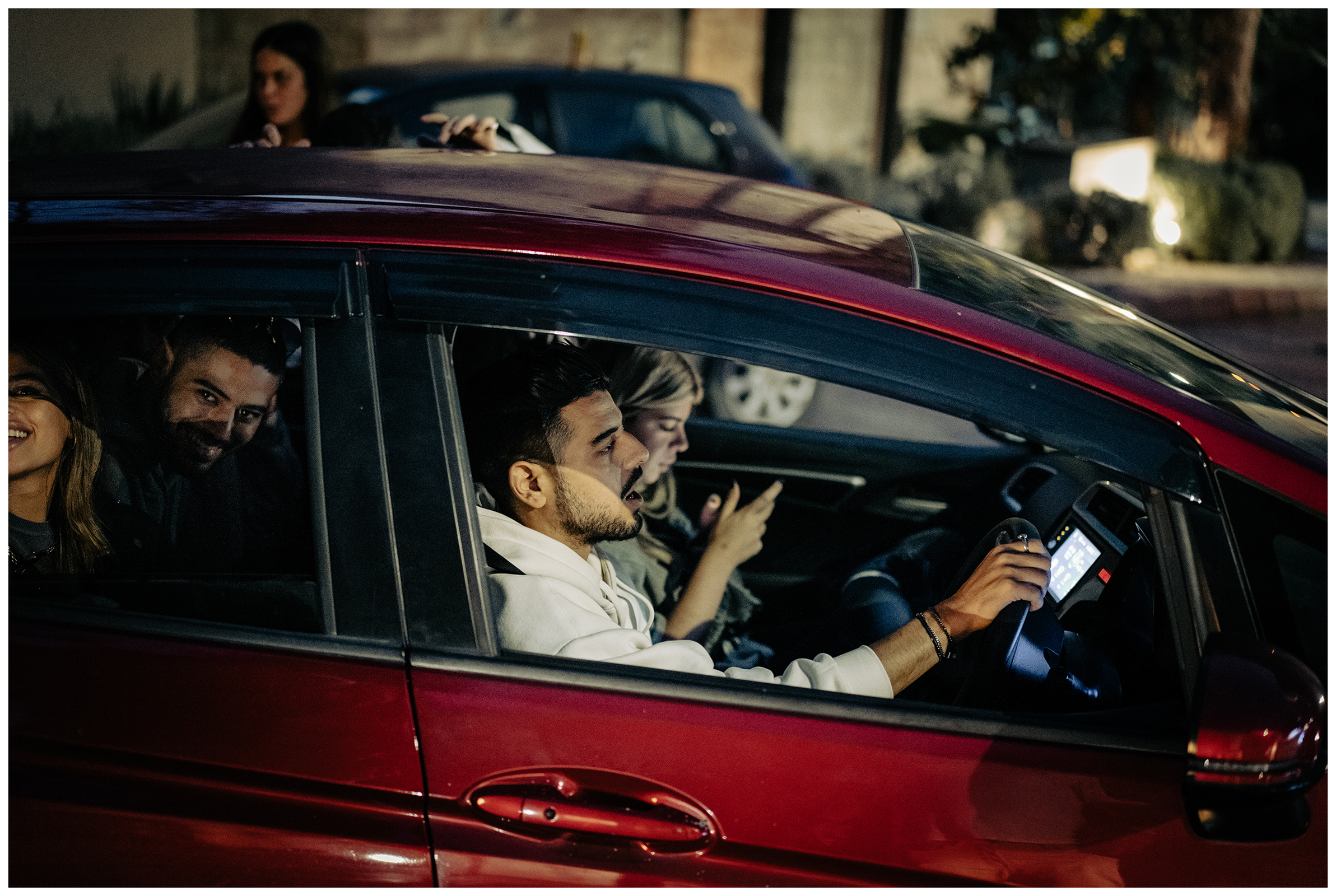 Miliou, Cyprus. Young Israelis leave the grounds of the Secret Forest wellness retreat late in the evening in a red car.